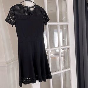 Black stretch dress can be dressed up or down Michael Kors size small